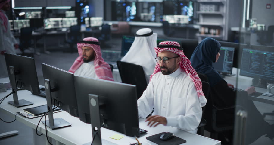Group of Multicultural Middle Eastern Men and Women Working in Research Center, Collaborating and Discussing a Project, Using Computers to Write Software Code, Develop Artificial Intelligence Service Royalty-Free Stock Footage #1102169157