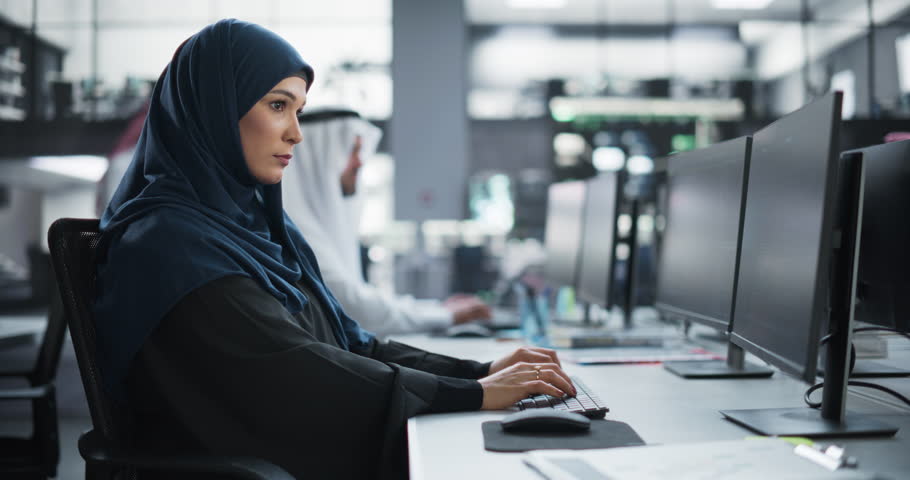 Beautiful Middle Eastern Computer Scientist Wearing a Hijab, Working on PC in a Technological Corporate Office. Young Muslim Woman Writing Software Code for an Innovative Online Service Project Royalty-Free Stock Footage #1102169197