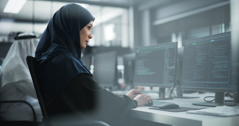 Arab Female Artificial Intelligence Engineer Working on Desktop Computer in a Startup Office. Young Middle Eastern Specialist Writing Software Code for an Innovative Big Data Blockchain Project | Shutterstock HD Video #1102169215