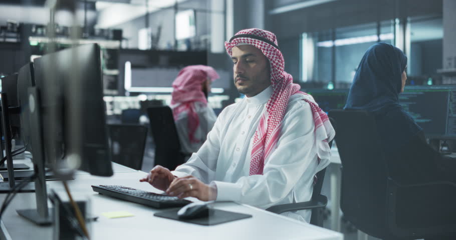 Diverse Young Muslim Colleagues Working on Computers in a Research Laboratory. Middle Eastern Men and Women Working on a Solution for Their Collaborative Industrial Tech Project Royalty-Free Stock Footage #1102169235
