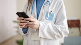 Young caucasian woman doctor using smartphone at clinic - Powered by Shutterstock - Get 15% off with code: PIKWIZARD15