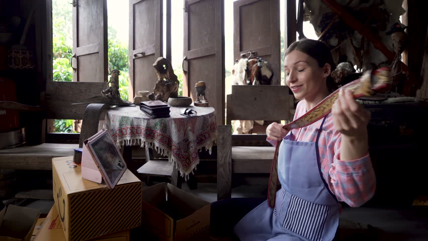 4K, This good-looking female handcrafted leather worker is selling online via laptop live stream, sit hold leather belt that is handmade every step way sell products through talking viewers.