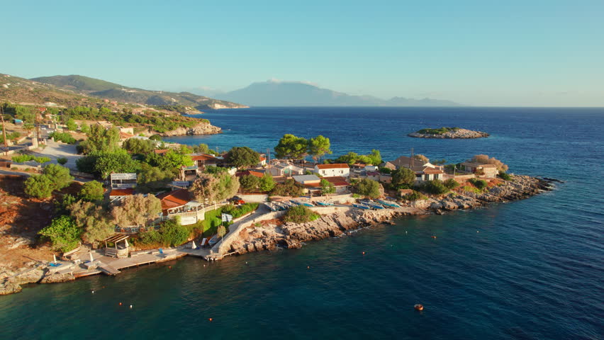 Picturesque Mikro Nisi village at sunset in Zakynthos Island, Greece, Europe. Aerial view. Small bay with turquoise sea water on Zante island. Greek holidays travel destination | Shutterstock HD Video #1102176711