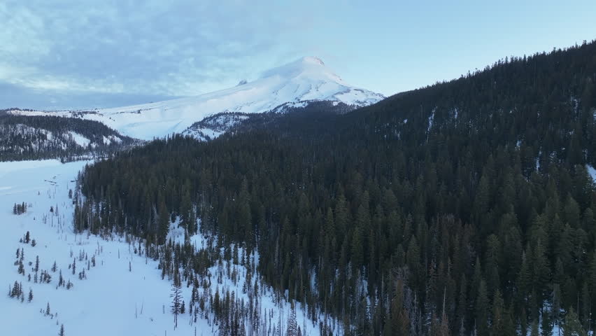 Early morning light shines on Mt Hood, an iconic stratovolcano found about 50 miles southeast of Portland, Oregon. Mt Hood has one of the longest ski seasons in the U.S. due to its annual snow pack.