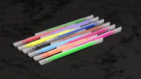 Set of felt-tip pens of different colors. Double-sided felt-tip pens. Multicolored markers or felt-tip pens on black. Side view. Loop motion. Rotation 360. 4K UHD video footage 3840X2160.