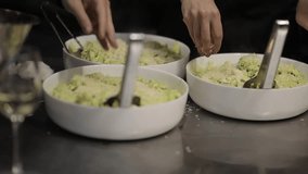 girls at the culinary master class are preparing a summer salad with cabbage and cheese, a girl is squeezing cheese into a salad with cabbage, slow motion video