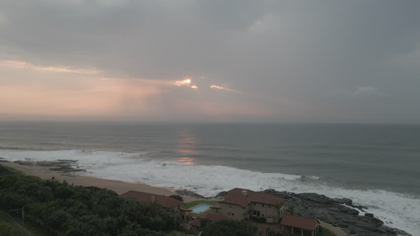 Tracking sideways shot of sunrise over the Indian Ocean from Durban, South Africa.