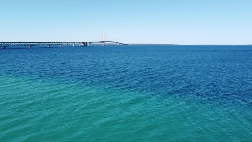 one flying over lake michigan mackinac bridge mackinac or mackinaw city and island with bridge cars people driving lake