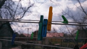 clothespin on the wind. clothes peg on a clothesline. clothes drying on a clothesline. multi-colored clothespins. 
