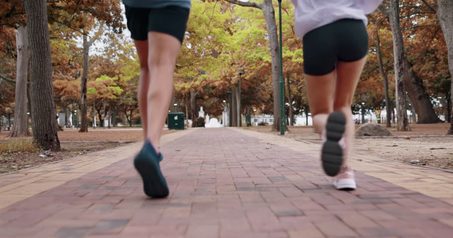 Park fitness, legs and running couple of friends doing cardio exercise, marathon training or active sports practice. Nature freedom, peace and back of athlete runner on outdoor performance workout