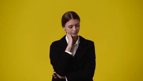 4k video of girl with cunning facial expression on yellow background.