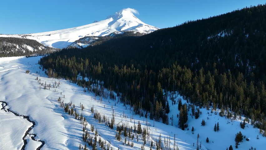 Early morning light shines on Mt Hood, an iconic stratovolcano found about 50 miles southeast of Portland, Oregon. Mt Hood has one of the longest ski seasons in the U.S. due to its annual snow pack.