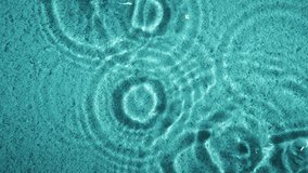 Top down view white sea sand, water droplets, blue ripple waves reflection on sea floor. Water rings on surface. Summer texture background - Powered by Shutterstock - Get 15% off with code: PIKWIZARD15