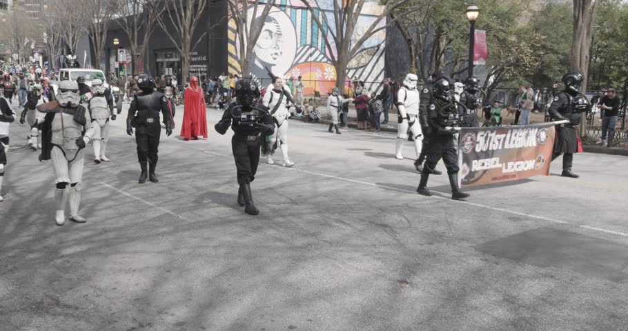 Atlanta, GA  USA – March 11, 2023:  Costumed Star Wars characters, including stormtroopers, Darth Vader, and Mandalorians, participate in the annual Atlanta St. Patrick’s parade on March 11, 2023  