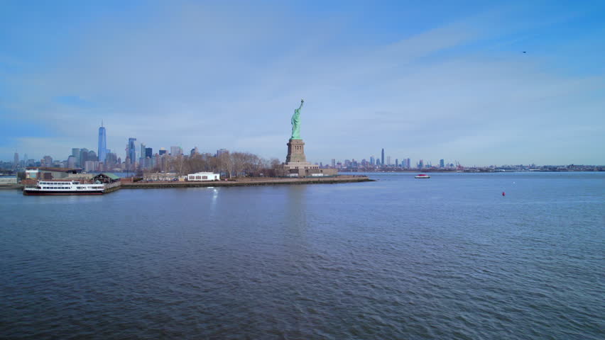Aerial view of Statue Liberty on background of New York. Drone view of Sttue Liberty and New York from Upper bay.