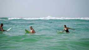 Young diverse women surfers floating on surfboards and riding waves in the ocean at sunrise. Surfer females sitting on surfing boards in calm sea looking at horizon. Girls enjoy water. 3D Illustration - Powered by Shutterstock - Get 15% off with code: PIKWIZARD15