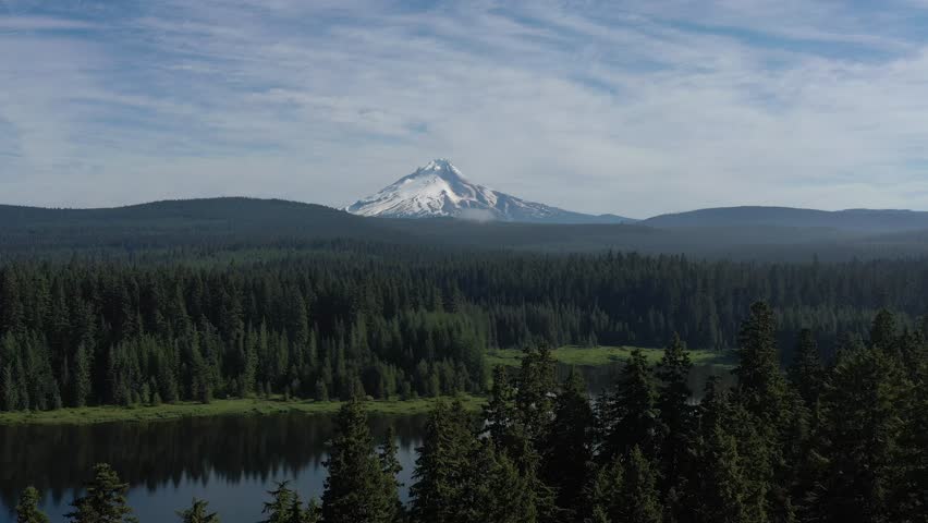 Aerial flying above trees at Timothy Lake toward Mt. Hood in Oregon.