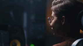 Close up shot of female editor makes color grading for video or film on computer in modern studio. Young woman edits photo, develops design project, plays video game. Big digital screen on background. - Powered by Shutterstock - Get 15% off with code: PIKWIZARD15