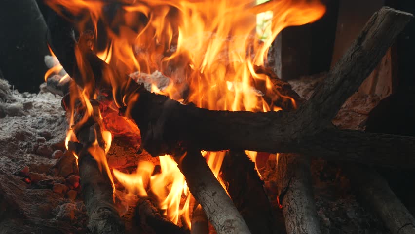 Close view at hot fireplace full of wood and fire.