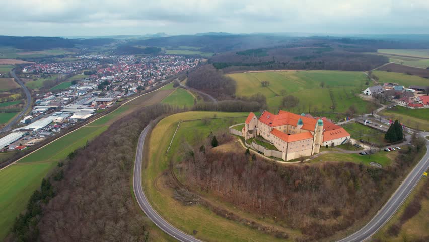 Aerial around the village Lauchheim and castle Kapfenburg on a cloudy day in late winter