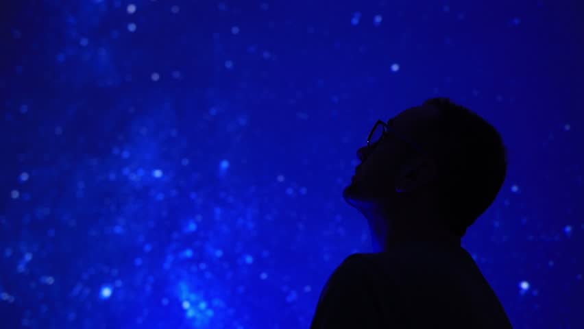 Silhouette of a man with Milky Way starry skies.