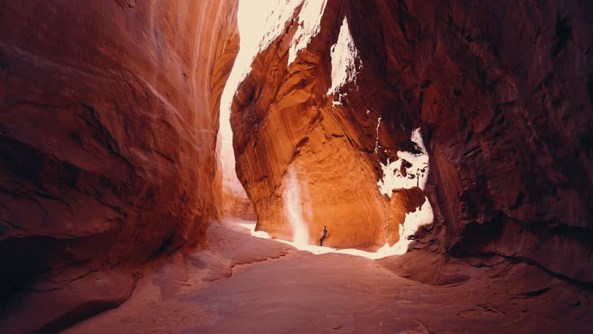 Wide shot of person walking in Utah slot canyon Royalty-Free Stock Footage #1102216261