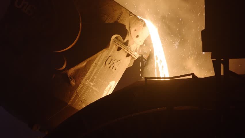 Pouring liquid molten metal from a ladle in a blast furnace. Liquid steel pouring out with bright sparks Royalty-Free Stock Footage #1102217207