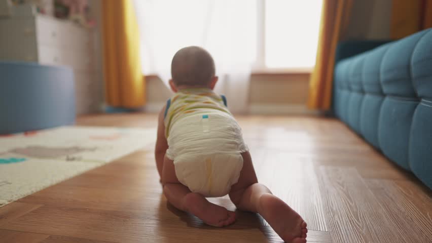 baby newborn crawling on floor. happy family kindergarten kid concept. First steps, baby crawling view from the back. baby learns to crawl to explore the world dream. lifestyle first steps creeps Royalty-Free Stock Footage #1102219709