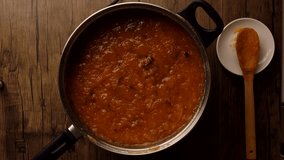 Top view Orange jam boiled in a saucepan. High quality 4k footage