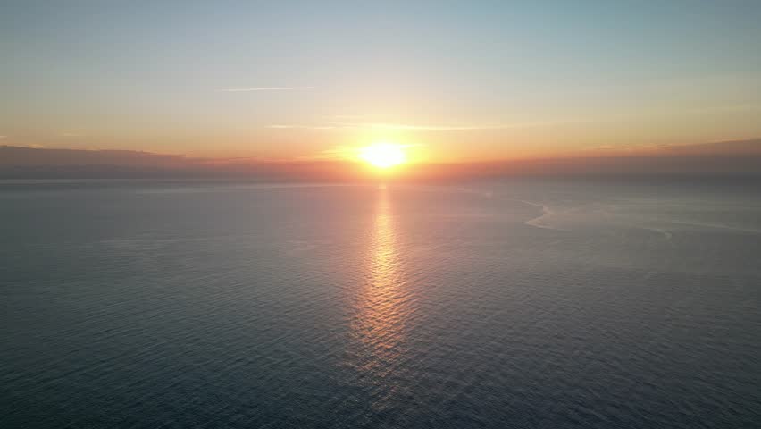 Sunset On The Horizon With Reflection On Idyllic Beach In Mallorca, Spain. Aerial Wide Shot
