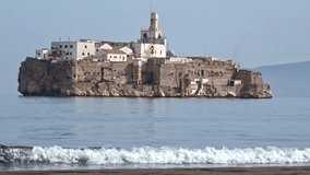 Waves crashing in a moroccan beach in front of the Alhucemas island, which is a spanish territory a few meters away. - Powered by Shutterstock - Get 15% off with code: PIKWIZARD15