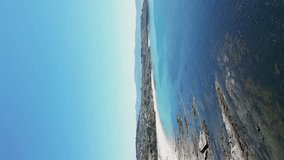 Vertical Video Aerial pullback of Sanxenxo Coastline, white sand stretch, Galiza