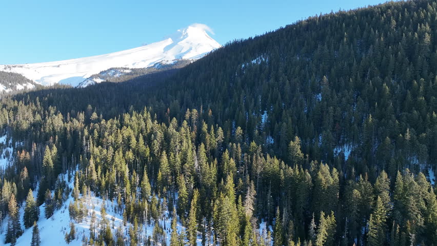 Early morning light shines on Mt Hood, an iconic stratovolcano found about 50 miles southeast of Portland, Oregon. Mt Hood has one of the longest ski seasons in the U.S. due to its annual snow pack.
