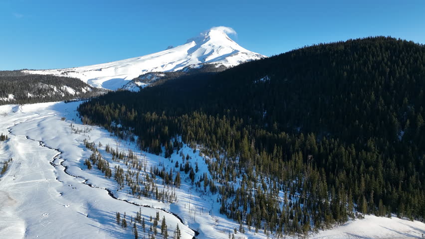 Early morning light shines on Mt Hood, an iconic stratovolcano found about 50 miles southeast of Portland, Oregon. Mt Hood has one of the longest ski seasons in the U.S. due to its annual snow pack.