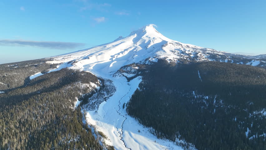 Early morning light shines on Mt Hood, an iconic stratovolcano found about 50 miles southeast of Portland, Oregon. Mt Hood has one of the longest ski seasons in the U.S. due to its annual snow pack.