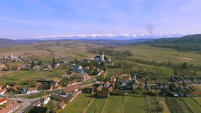 Aerial video of the fortified church located in Hosman village, Sibiu county, Romania. Footage was shot from a drone while flying backwards, away from the fortification.