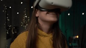 Young woman playing on guitar using VR helmet indoor. Girl playing on guitar with wearable VR. Virtual concert at home. - Powered by Shutterstock - Get 15% off with code: PIKWIZARD15