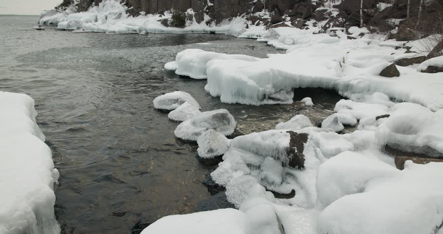 Lake Superior in Winter Waves Rocks Snow Ice by Shore
