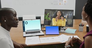 African american businesswomen on computer video call and talking in office. Business, finance, data processing and technology.