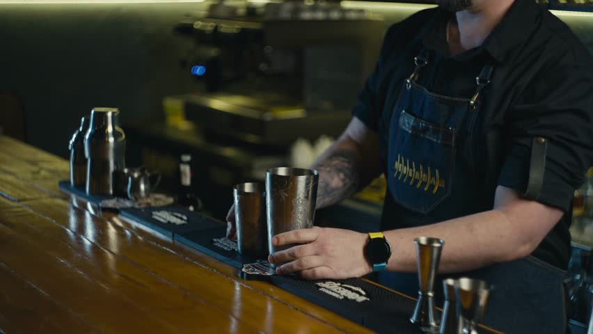 Close-up of a classy bartender making an alcoholic cocktail in a shaker. The work of a professional at the bar. High quality 4k footage Royalty-Free Stock Footage #1102233151