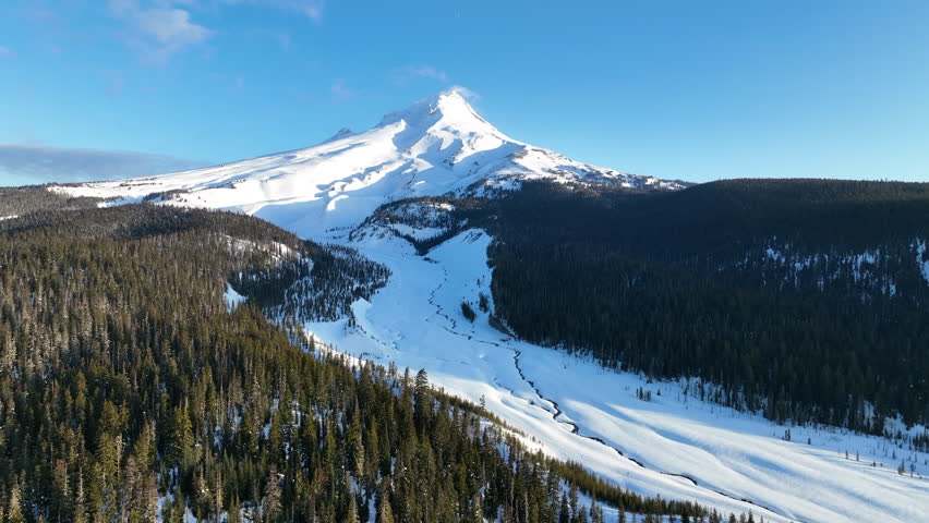 Early morning light shines on Mt Hood, an iconic stratovolcano found about 50 miles southeast of Portland, Oregon. Mt Hood has one of the longest ski seasons in the U.S. due to its annual snow pack.