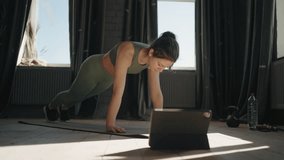 Online Sport Training, Young Woman Doing Physical Exercises On Floor In Front Tablet With Tutorial