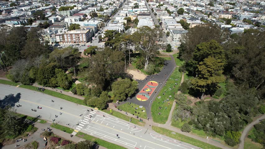Roller Skating in Golden Gate Park, San Francisco. Shot from drone with houses in background.