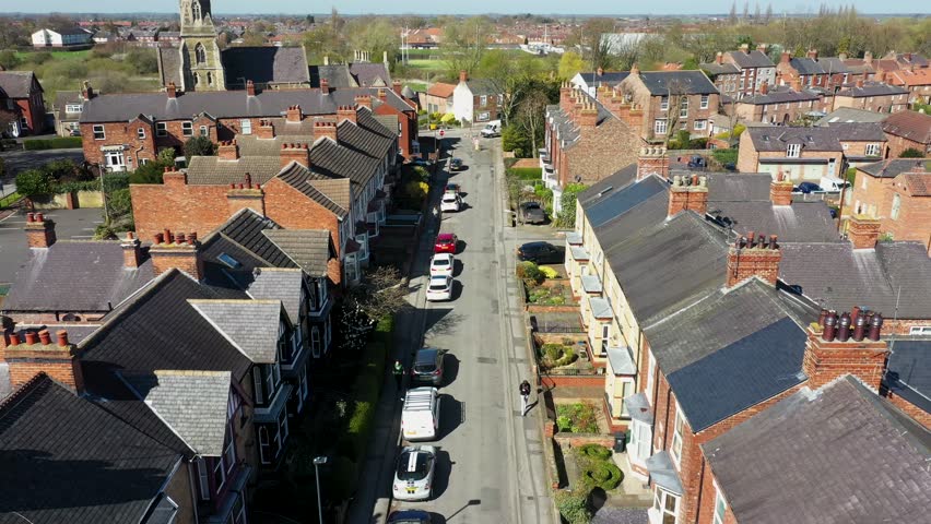 Aerial drone footage of the British town centre of Shipley, a historic market town and civil parish in the City of Bradford, West Yorkshire, England on a bright sunny summers day showing the roof top Royalty-Free Stock Footage #1102243627
