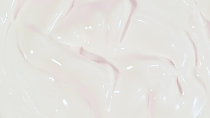 Super Slow Motion Shot of Fresh Strawberries Falling into Swirling Cream at 1000fps.