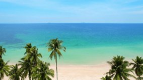 Drones are capturing stunning aerial footage as they fly over lush coconut palms and onto picturesque beaches and tropical seas in Thailand, creating a breathtaking visual experience. 4K HDR
