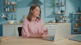 Freelance Young Woman Drink a Glass of Clean Water in Kitchen. Smiling Woman Start New Day with Healthy Life Habit, Holding Glass Drinking Clean Mineral Natural Water. Lifestyle Healthcare Concept. - Powered by Shutterstock - Get 15% off with code: PIKWIZARD15