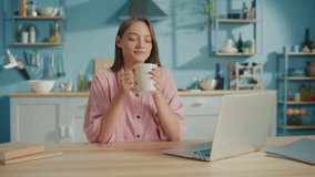 Smiling Business Woman Having Coffee Break at Work from Home. Portrait of Relaxed Young Woman Drinking Cup of Tea While Working on The Laptop. Concept of Freelance and Modern Technology. - Powered by Shutterstock - Get 15% off with code: PIKWIZARD15