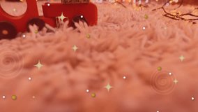 Animation of christmas seasons greetings in spanish over christmas decorations. christmas tradition and celebration concept digitally generated video.