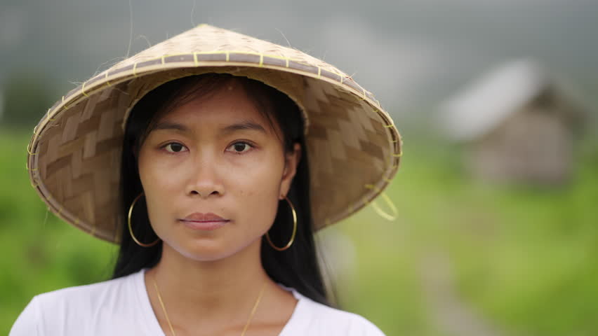 Portrait of serious young asian woman farmer, people emotions looking at camera